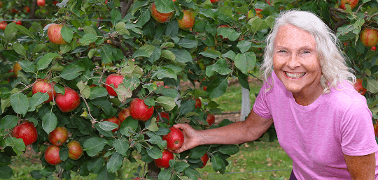 Image of Lisa Shuh in an apple orchard