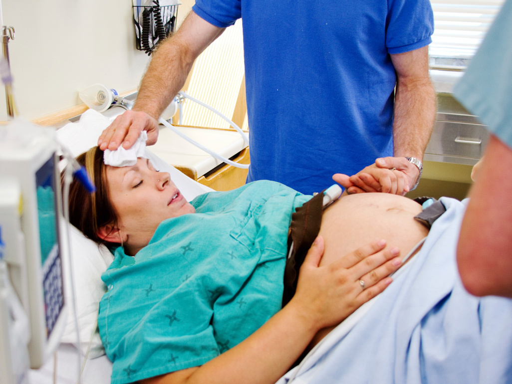 Woman in labour with medical staff around her